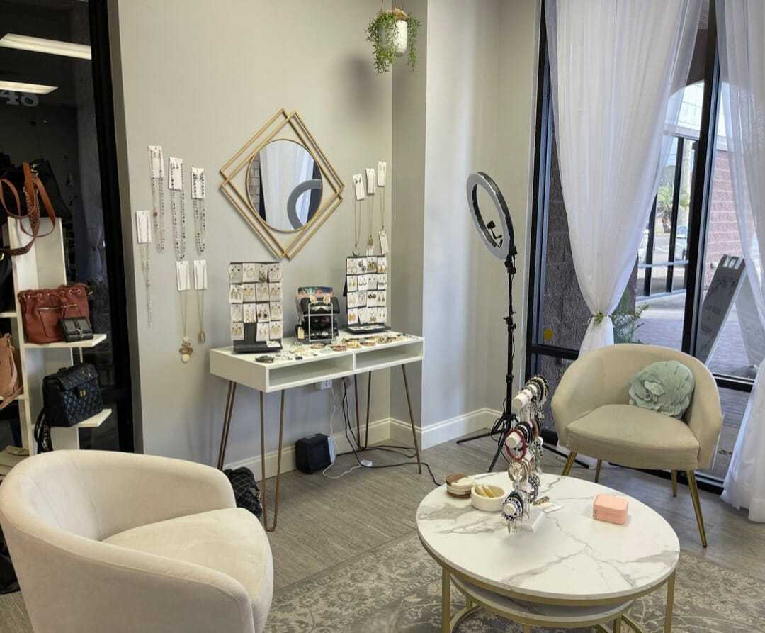 Chic jewelry and accessory display in a stylish boutique with modern decor and elegant seating.